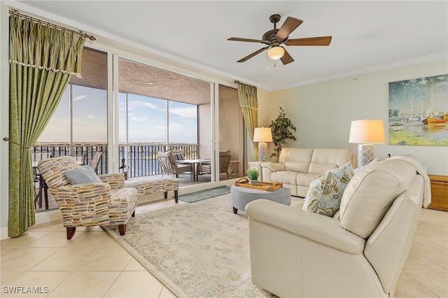 tiled living room with ceiling fan, expansive windows, and crown molding