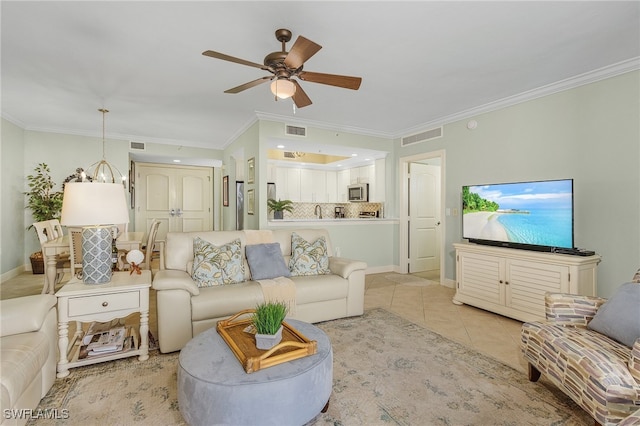 tiled living room featuring crown molding and ceiling fan