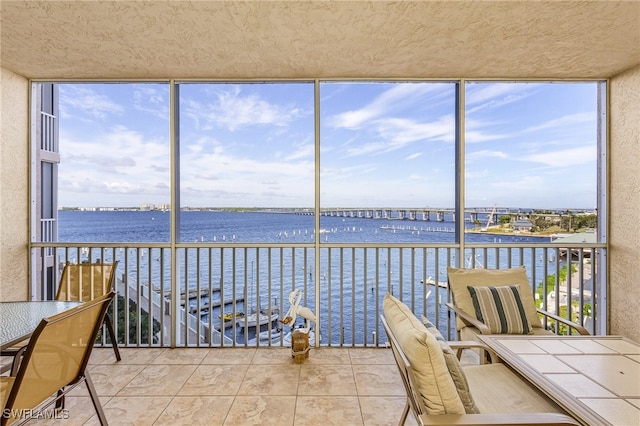 unfurnished sunroom with a water view