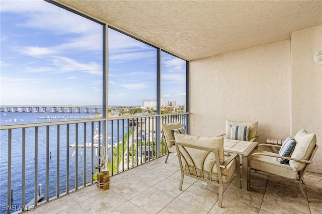 sunroom / solarium with a water view