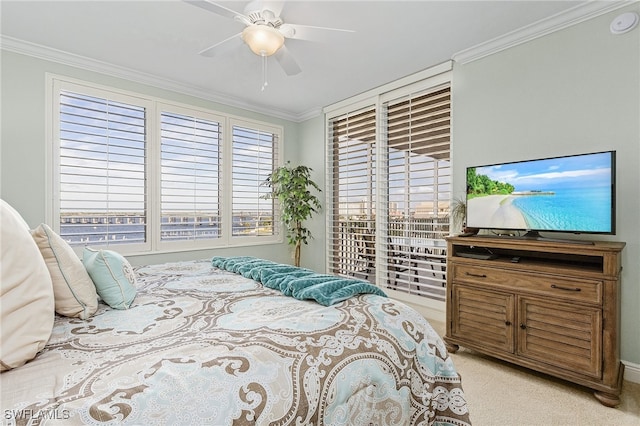 bedroom featuring ceiling fan, crown molding, and light colored carpet