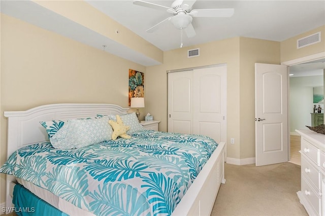 carpeted bedroom featuring ceiling fan and a closet