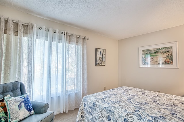 bedroom featuring carpet and a textured ceiling