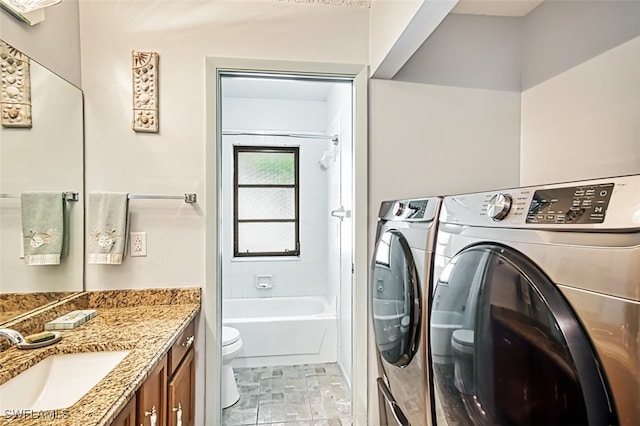 clothes washing area with independent washer and dryer and sink