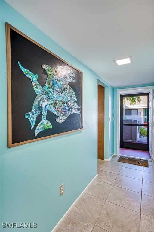 hall featuring light tile patterned flooring