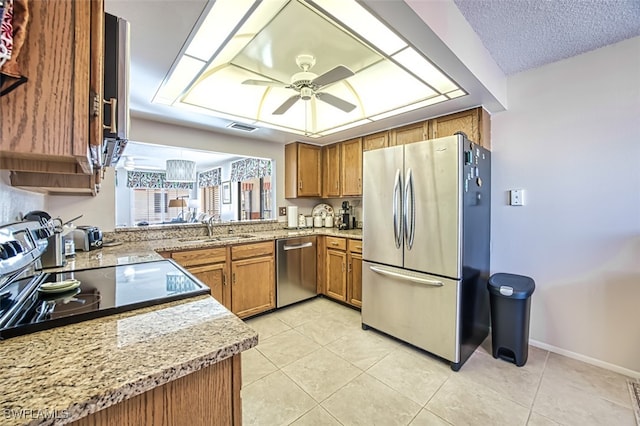 kitchen with ceiling fan, light tile patterned floors, sink, and appliances with stainless steel finishes