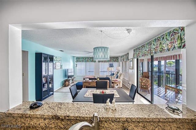 kitchen with light tile patterned flooring and a textured ceiling