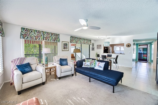 living room with light tile patterned floors, a textured ceiling, and ceiling fan