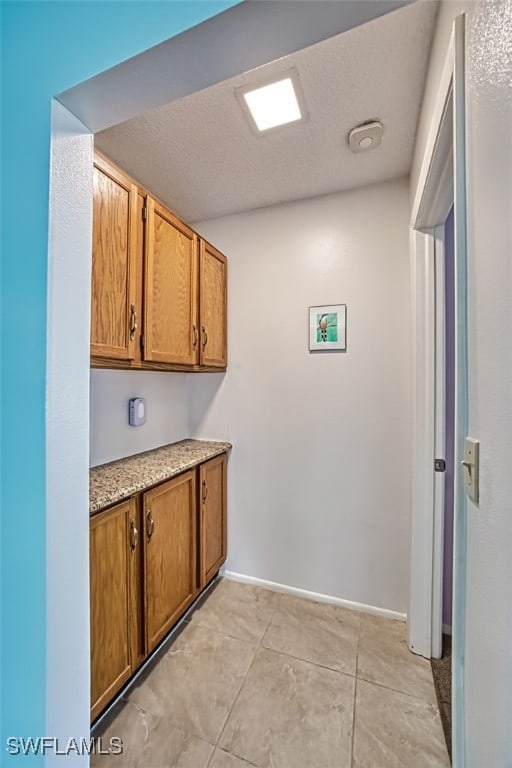 kitchen featuring light tile patterned floors and a textured ceiling