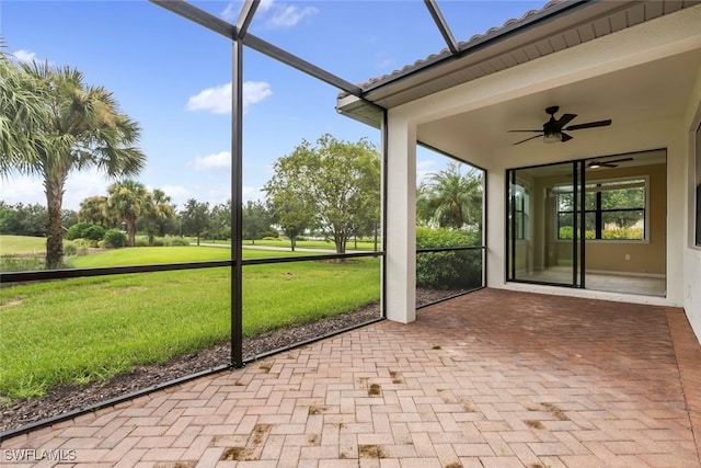 unfurnished sunroom featuring ceiling fan