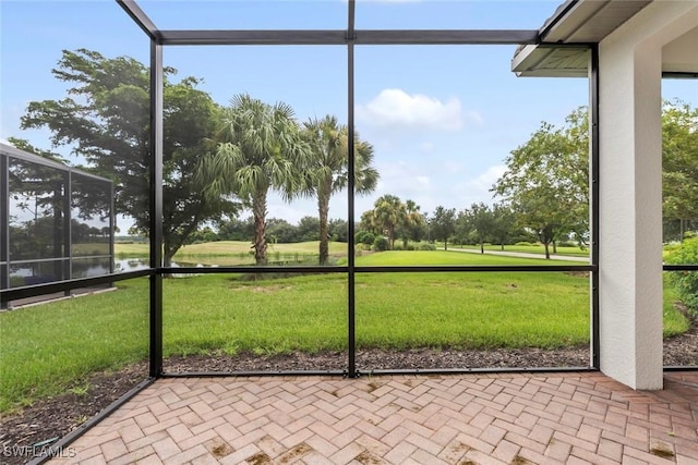 unfurnished sunroom with a water view