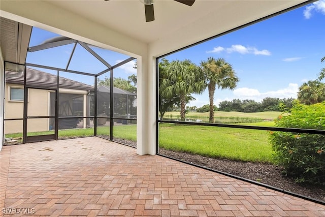 unfurnished sunroom featuring ceiling fan