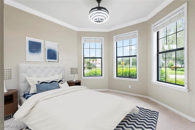 carpeted bedroom with ornamental molding