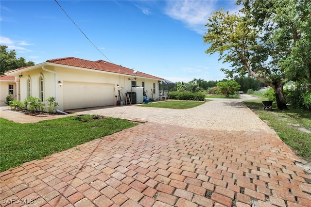 view of side of property featuring a yard and a garage