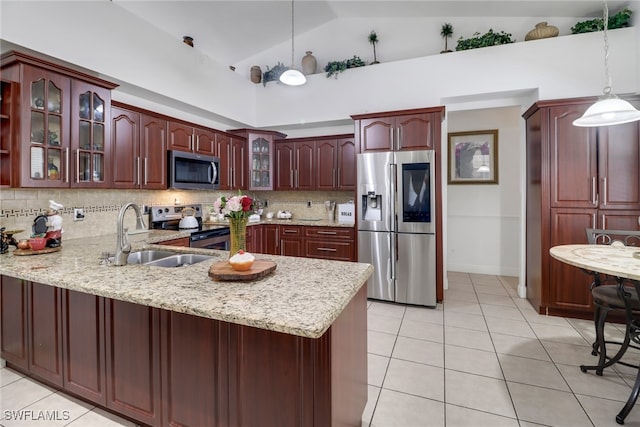 kitchen featuring hanging light fixtures, appliances with stainless steel finishes, high vaulted ceiling, backsplash, and light tile patterned flooring