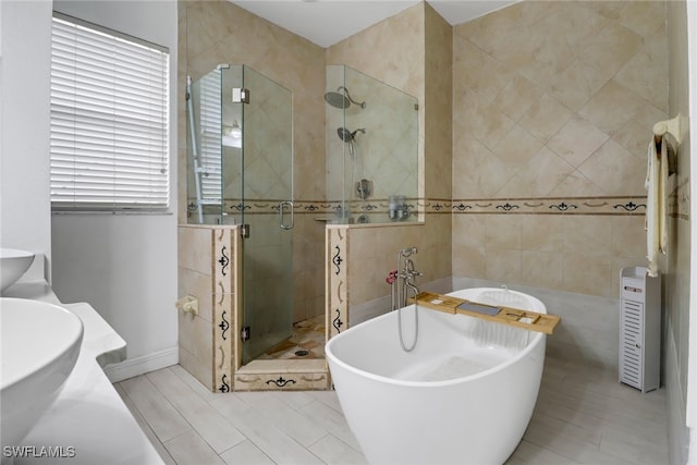 bathroom with tile patterned floors and independent shower and bath