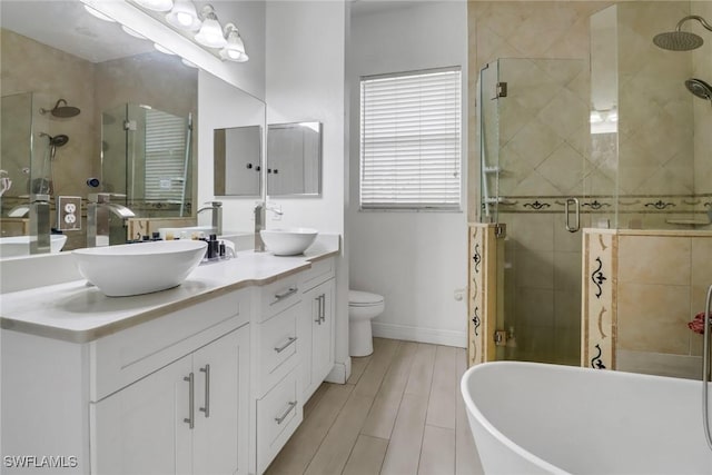 3711 4th Ave SE, Naples, FL 34117 - full bath featuring double vanity, a shower stall, a freestanding bath, baseboards, and toilet