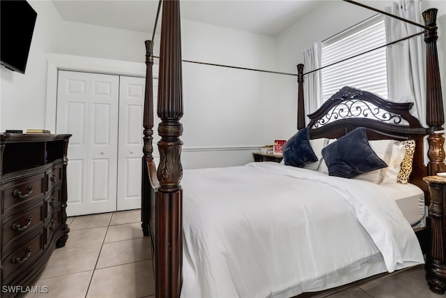 tiled bedroom with a closet