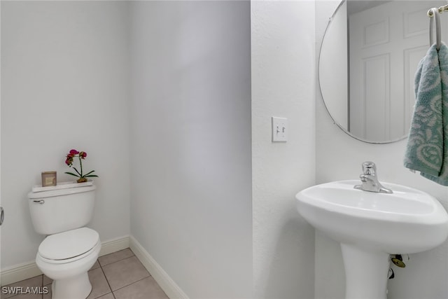 bathroom featuring toilet and tile patterned flooring