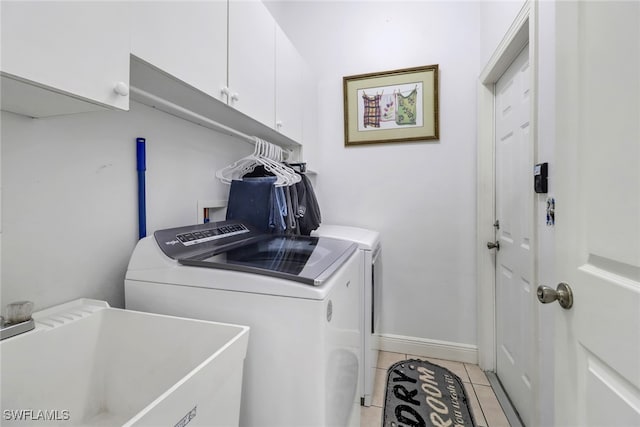3711 4th Ave SE, Naples, FL 34117 - washroom with separate washer and dryer, cabinet space, light tile patterned flooring, and baseboards