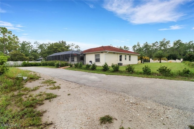 3711 4th Ave SE, Naples, FL 34117 - view of front of house featuring stucco siding and a front lawn