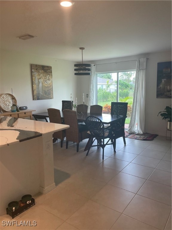 dining space featuring light tile patterned flooring