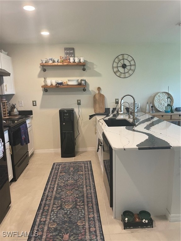 kitchen with white cabinets, sink, electric range, and light stone countertops