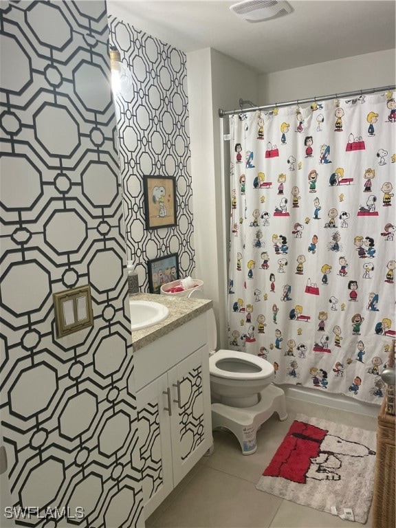 bathroom with vanity, toilet, and tile patterned flooring