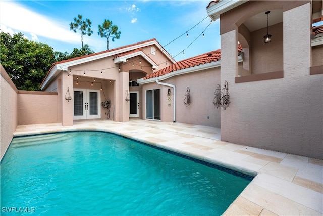 view of swimming pool featuring a patio area and french doors