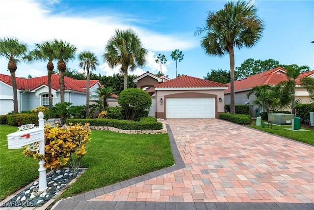 mediterranean / spanish-style home featuring a front yard and a garage