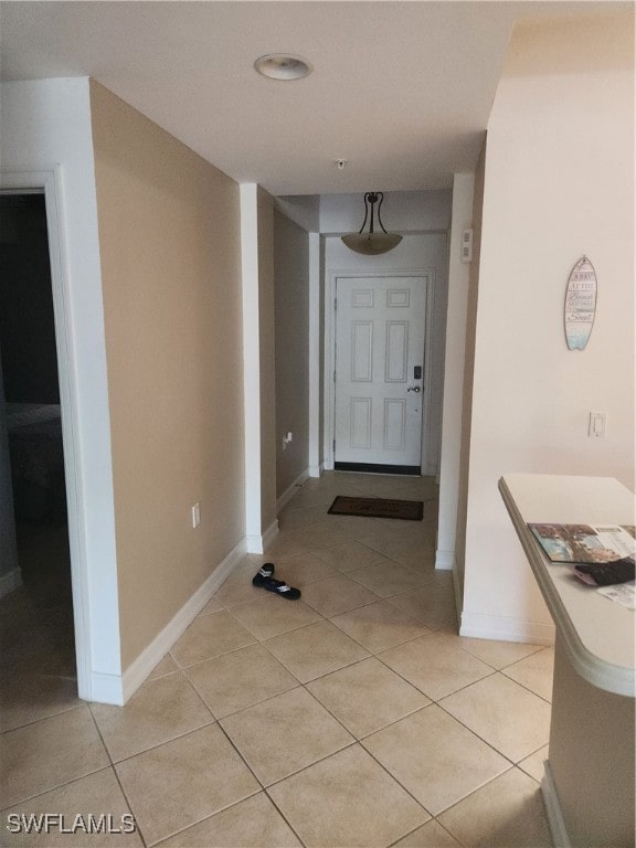 hall featuring light tile patterned flooring