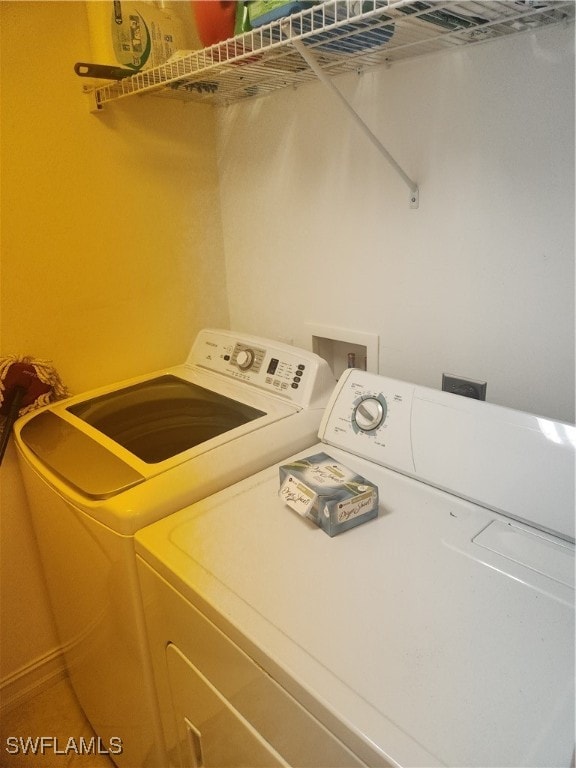 clothes washing area featuring washer and clothes dryer