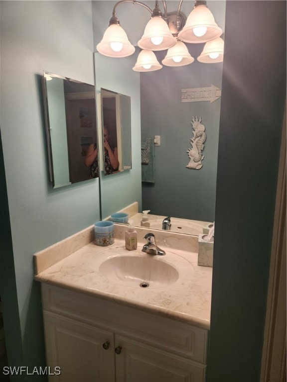 bathroom featuring vanity and an inviting chandelier