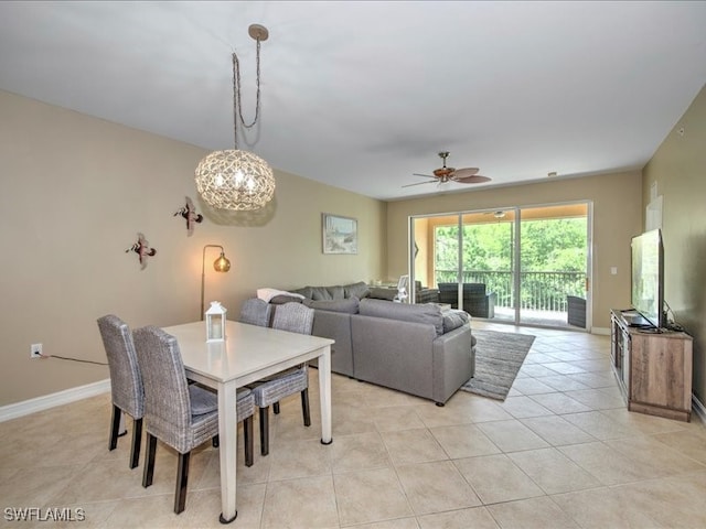 dining area with ceiling fan with notable chandelier and light tile patterned floors