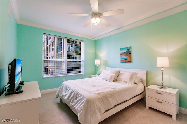 bedroom with ceiling fan, light colored carpet, and crown molding