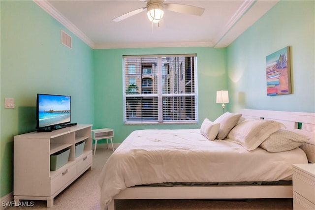 bedroom featuring light carpet, ceiling fan, and crown molding