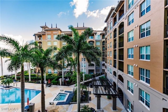 view of pool with a hot tub and a patio area