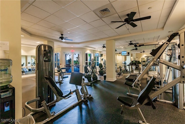 workout area featuring a paneled ceiling and french doors