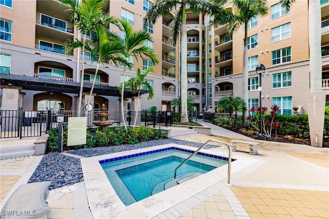 view of swimming pool with a community hot tub