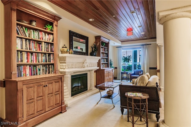 sitting room with built in shelves, light colored carpet, and wood ceiling