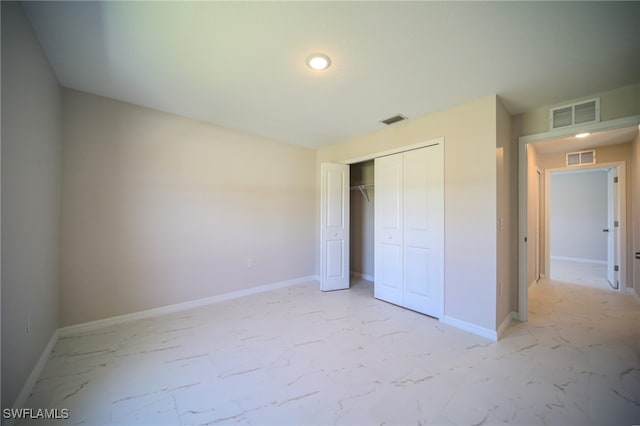 unfurnished bedroom featuring light tile patterned flooring and a closet