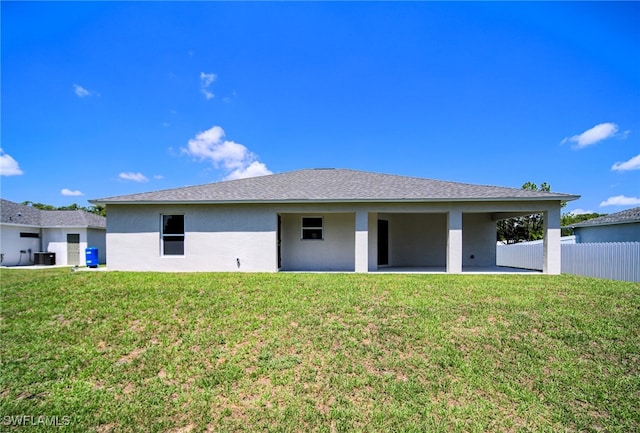 back of house with a patio area, central air condition unit, and a lawn