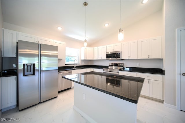 kitchen with appliances with stainless steel finishes, light tile patterned floors, pendant lighting, and white cabinetry