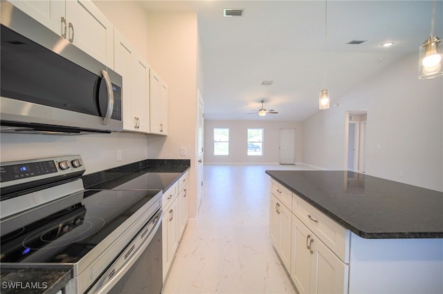 kitchen featuring pendant lighting, stainless steel appliances, and white cabinetry