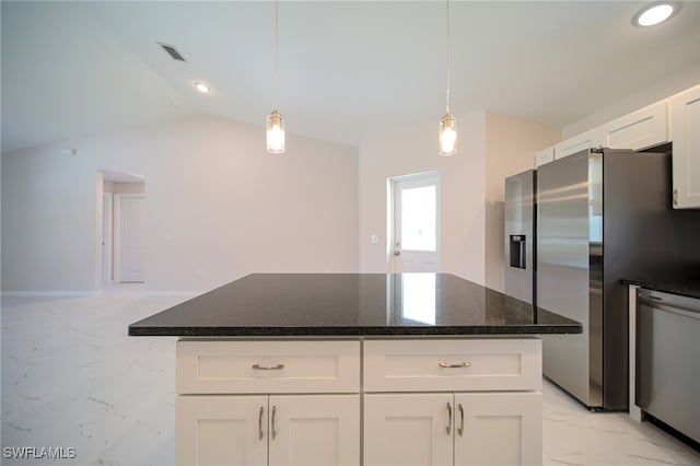 kitchen featuring appliances with stainless steel finishes, a center island, white cabinets, light tile patterned floors, and vaulted ceiling