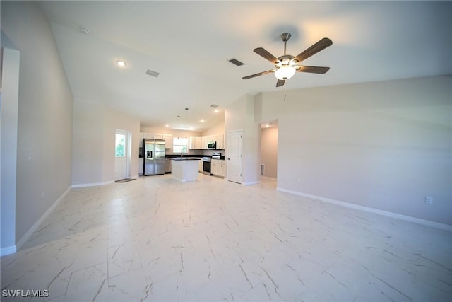 unfurnished living room with vaulted ceiling and ceiling fan