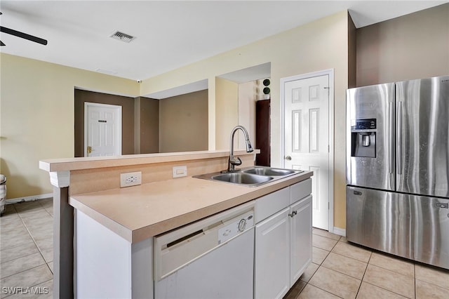 kitchen with stainless steel refrigerator with ice dispenser, light tile patterned floors, dishwasher, sink, and white cabinetry