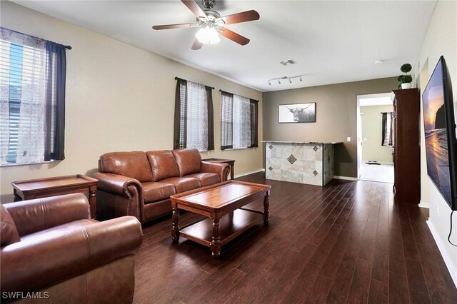 living room with ceiling fan, dark hardwood / wood-style flooring, and rail lighting