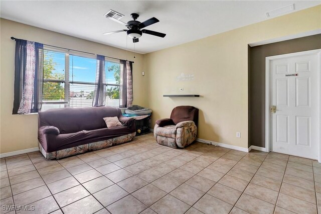 tiled living room featuring ceiling fan