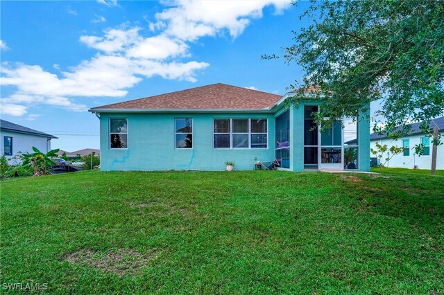 rear view of property featuring a yard